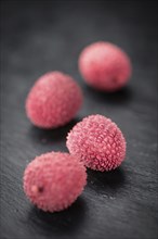 Litchis on a vintage slate slab (close-up shot, selective focus)