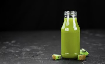 Fresh made Kiwi Smoothie (selective focus) on a vintage looking background