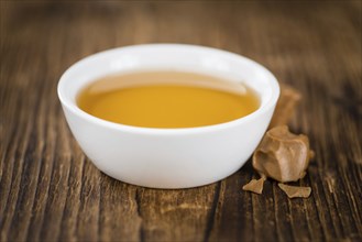 Caramel Sirup on a vintage background as detailed close-up shot (selective focus)