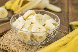 Sliced Bananas on a vintage background as detailed close-up shot, selective focus