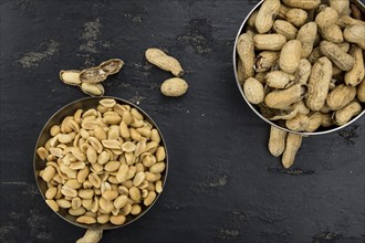 Roasted Peanuts on a vintage slate slab (selective focus, close-up shot)