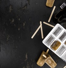 Slate slab with cola popsicles (homemade) as detailed close-up shot (selective focus)