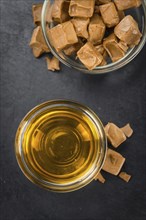 Caramel Sirup on a vintage background as detailed close-up shot (selective focus)