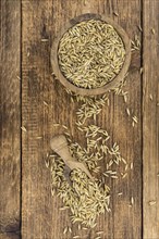 Wooden table with Oat (detailed close-up shot, selective focus)