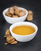 Portion of fresh Caramel Sirup (close-up shot, selective focus)