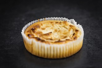 Some fresh Cheesecake on a vintage slate slab (selective focus, close-up shot)