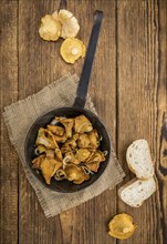 Fresh made Fried Chanterelles on a vintage background as detailed close-up shot