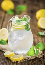 Homemade Lemonade on vintage background (selective focus, close-up shot)