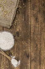 Vintage wooden table with Oat Flour (selective focus, close-up shot)