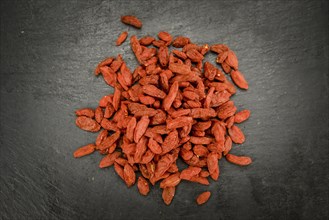 Fresh made Dried Goji Berries on a vintage background (close-up shot)