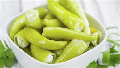 Fresh made Green Chilis (filled with cheese) on an old and rustic wooden table (selective focus,