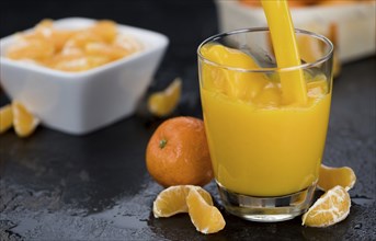 Tangerine Juice (close-up shot) on a vintage looking slate slab