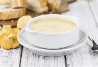 Fresh made Chanterelle Soup on a vintage background as detailed close-up shot