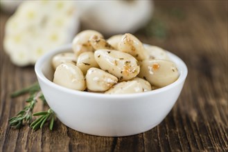 Fresh made Garlic (preserved) on a vintage background (close-up shot)