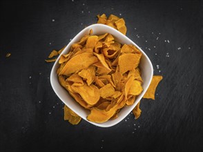 Homemade Sweet Potato Chips on vintage background selective focus, close-up shot