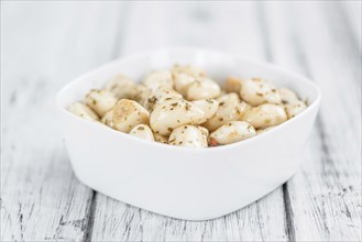 Portion of fresh Preserved Garlic (close-up shot, selective focus)