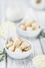 Fresh made Garlic (preserved) on a vintage background (close-up shot)