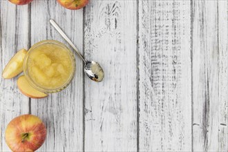 Homemade Applesauce (selective focus, close-up shot) on vintage background with some fresh fruits