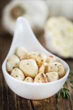 Portion of fresh Preserved Garlic (close-up shot, selective focus)