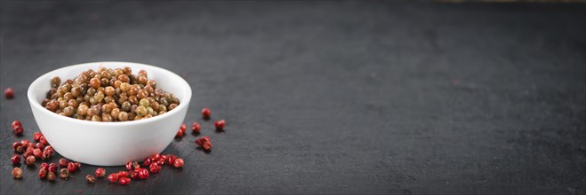 Portion of fresh preserved Pink Peppercorns close-up shot, selective focus