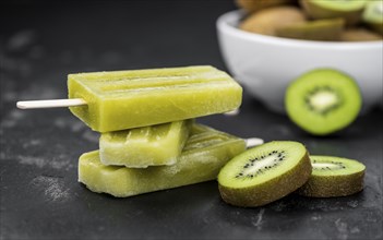 Kiwi Popsicles on a vintage looking slate slab (selective focus)