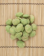 Wasabi Peanuts on a vintage background as detailed close-up shot (selective focus)