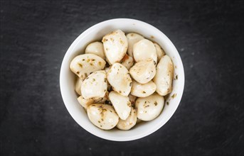 Fresh made Garlic (preserved) on a vintage background (close-up shot)