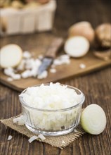 Diced white onions on a vintage background as detailed close-up shot, selective focus