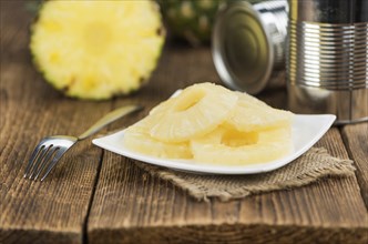 Fresh made Preserved Pineapple Rings on a vintage background as detailed close-up shot