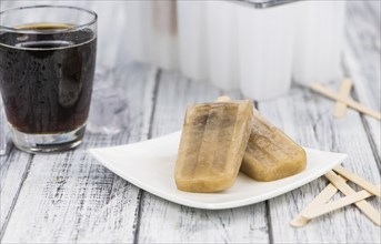 Cola Popsicles (selective focus) on a vintage background as detailed close-up shot