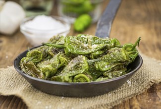 Pimientos de Padron on a vintage background as detailed close-up shot, selective focus