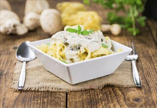 Homemade Porcini pasta on vintage background selective focus, close-up shot