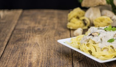 Porcini pasta on an old wooden table as detailed close-up shot, selective focus