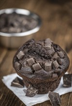 Vintage wooden table with Chocolate Muffins (selective focus, close-up shot)