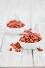 Fresh made Dried Goji Berries on a vintage background (close-up shot)