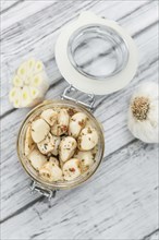 Portion of fresh Preserved Garlic (close-up shot, selective focus)