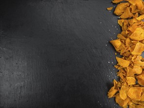 Some fresh Sweet Potato Chips on a vintage slate slab, selective focus, close-up shot