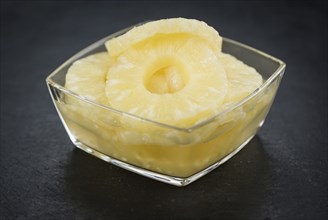 Fresh made Preserved Pineapple Rings on a vintage background as detailed close-up shot