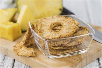 Dried Pineapple Rings on a vintage background as detailed close-up shot, selective focus