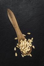 Portion of fresh Pine Nuts (close-up shot, selective focus)