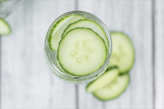 Cucumber Water on rustic wooden background as close-up shot