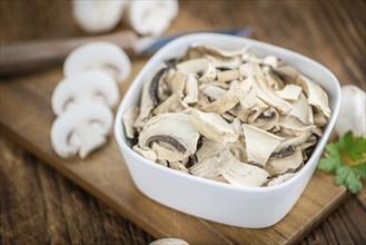 Dried Mushrooms (Agaricus) on an old wooden table as detailed close-up shot, selective focus