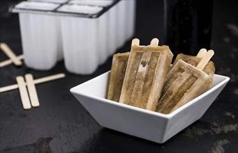 Cola Popsicles (selective focus) on a vintage background as detailed close-up shot