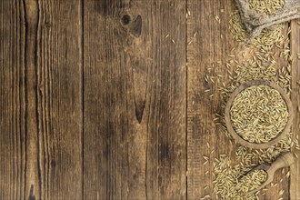 Old wooden table with fresh Oat (close-up shot, selective focus)