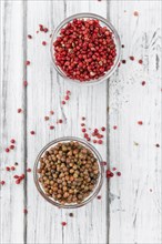 Portion of fresh preserved Pink Peppercorns close-up shot, selective focus