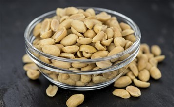 Roasted Peanuts on a vintage slate slab (selective focus, close-up shot)