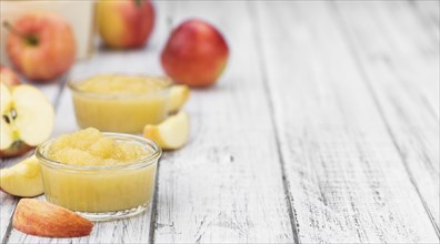 Homemade Applesauce (selective focus, close-up shot) on vintage background with some fresh fruits