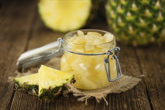 Fresh made Chopped Pineapple (preserved) on an old and rustic wooden table, selective focus,