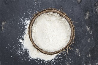 Some fresh made Coconut flour on a vintage slate slab (selective focus)