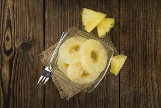 Preserved Pineapple Rings on a vintage background as detailed close-up shot, selective focus